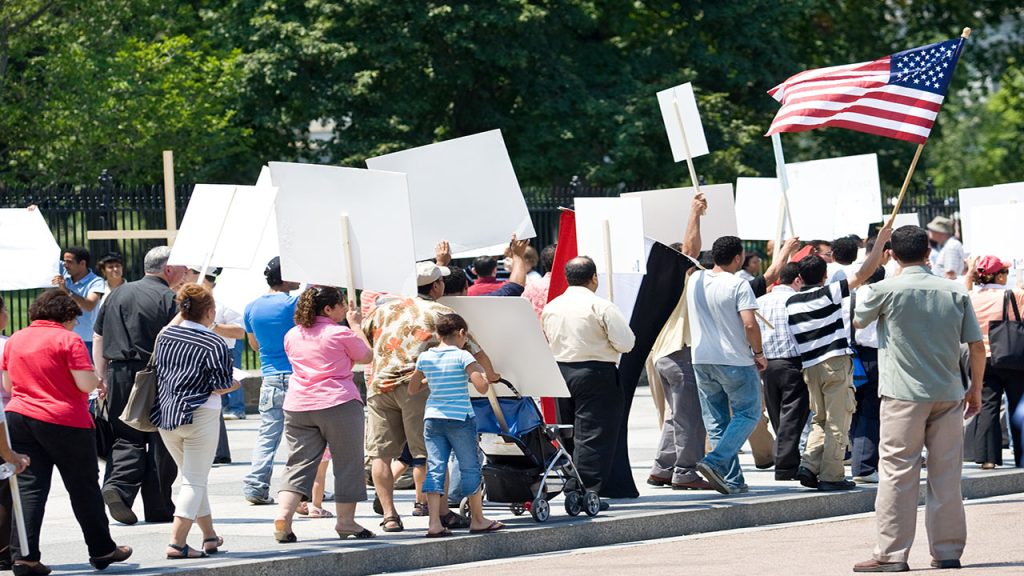 A group of peaceful protestors with banners and posters