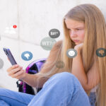 Sad girl viewing negative reactions and comments on social media, concept of children online bullying.
