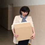 A frustrated teacher with a box in his hands quits.